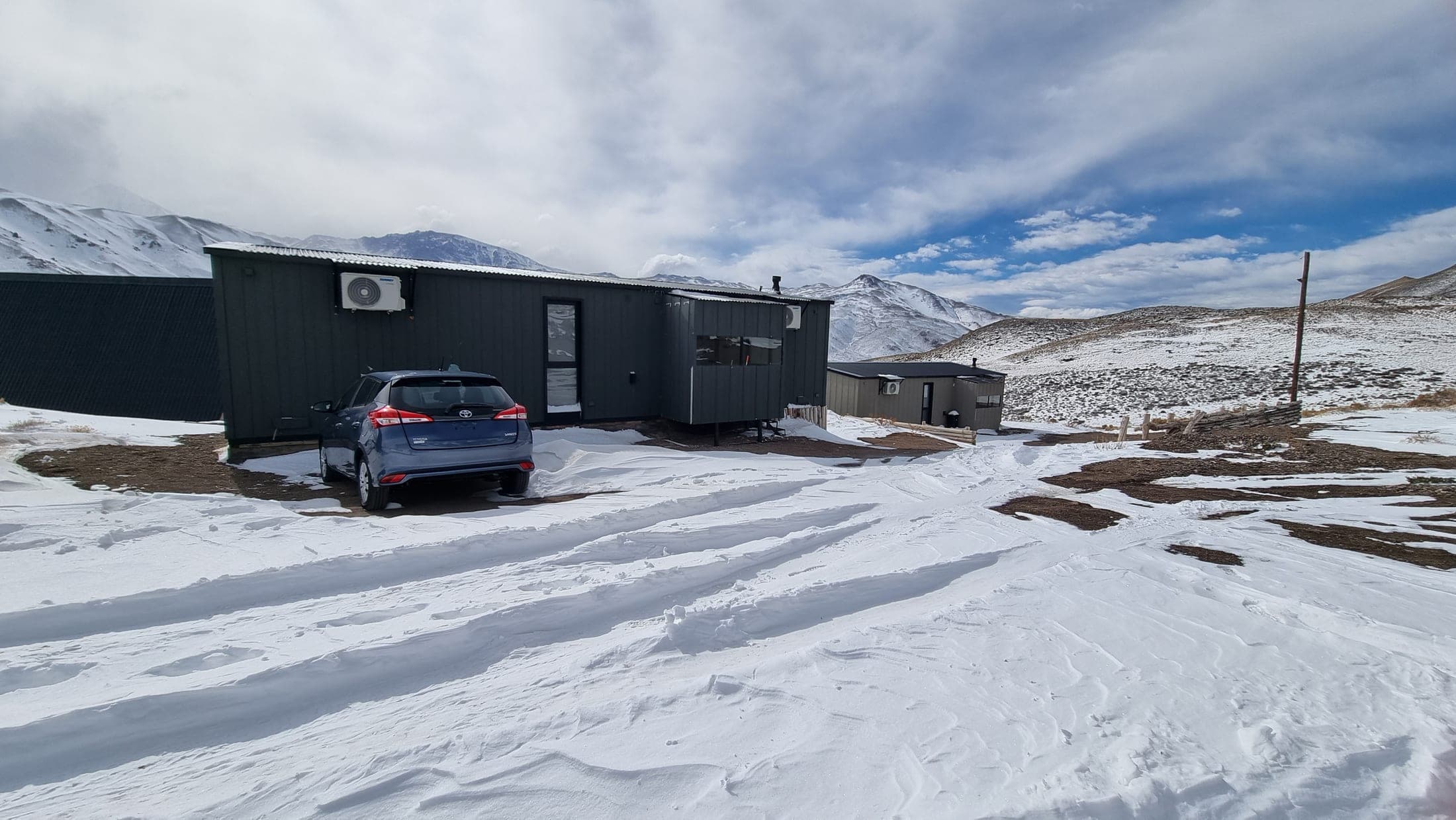 Cabañas de Summit Trip Winter Lodge sobre la nieve, con la cordillera de fondo